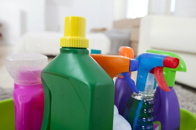 Farverige rengøringsprodukt plastflasker og spray på køkkenbenken