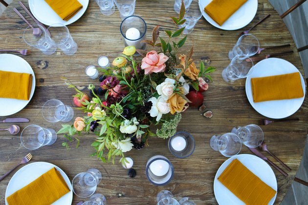 Floral middelpunt voor Thanksgiving centerpieces op Tablescapes met witte borden en okerkleurige servetten