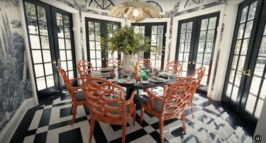 La sala da pranzo di RuPaul presenta una combinazione di colori in bianco e nero, sedie arancioni arricciate e carta da parati naturale.