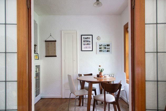 Sala da pranzo minimalista con tavolo e sedie moderni e arte della parete