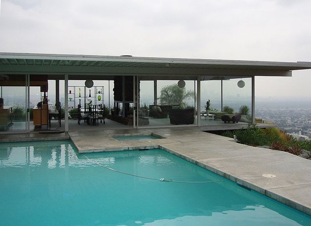 casa con pareti di vetro vicino a una piscina