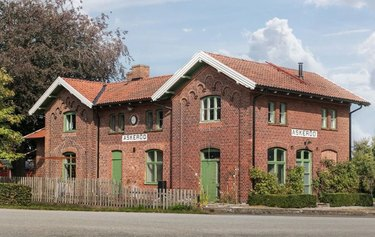 casa in mattoni rossi con accenti verde erba