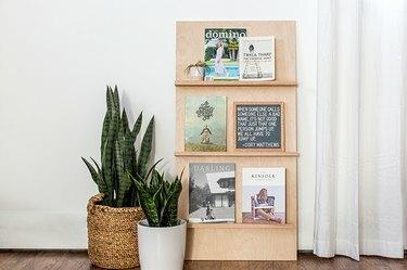 um porta-revistas feito de madeira compensada e prateleiras de carvalho
