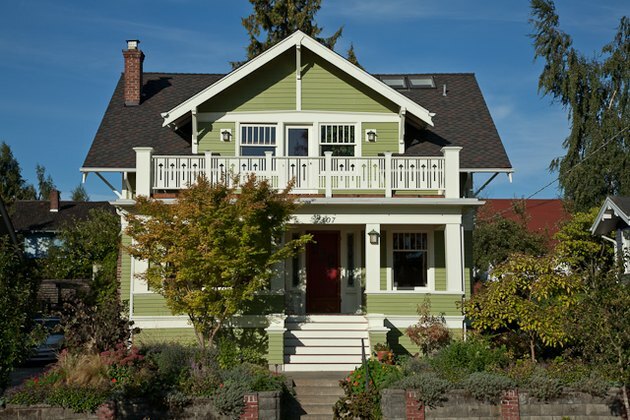 فكرة المنزل الخارجي التقليدية للمنزل الأخضر مع باب لهجة حمراء
