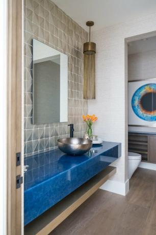 badkamer backsplash idee met geometrische tegels en blauwe zwevende ijdelheid