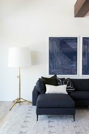 marineblauw woonkamer idee van Studio Mcgee ontworpen met blauwe bank en kunstwerken