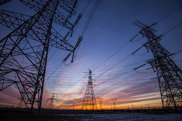 Het silhouet van de avond pyloon van de elektriciteitstransmissie