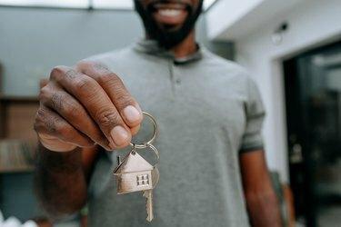 איש מחזיק מפתחות לבית חדש