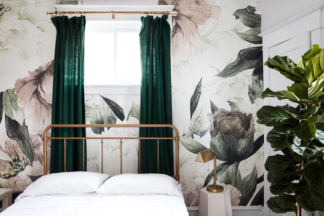 quarto com papel de parede floral e cortina verde
