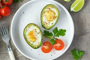 Gebakken avocado-eieren op een wit bord