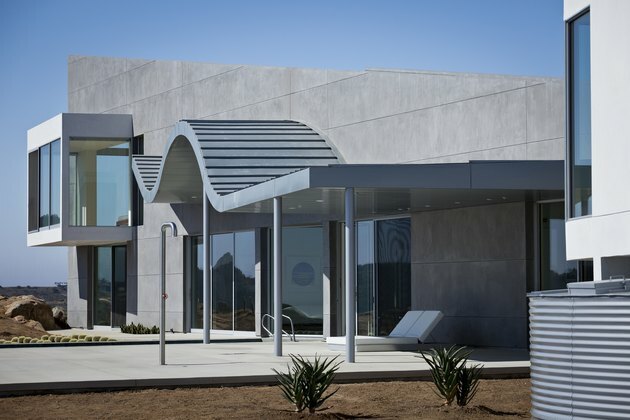 Casa Bauhaus com projeção curva e materiais de concreto e aço
