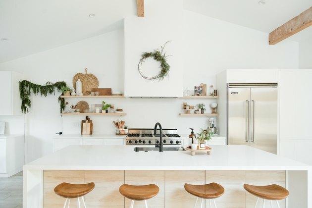 keukeneiland decor op houten footed dienblad in minimalistische keuken met groene krans