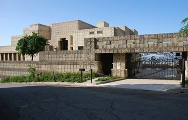 Ennis House, suuri betoninen geometrinen talo aidatulla ajotiellä.