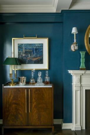 Woonkamer geschilderd groenblauw met gouden accenten