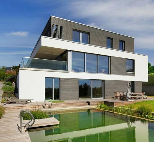 Casa Bauhaus com piscina no quintal e móveis de exterior