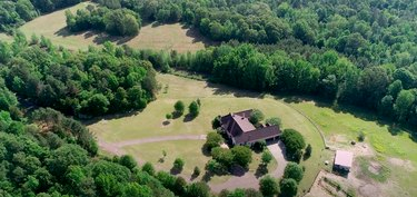 vista aérea da casa com árvores e natureza nas proximidades
