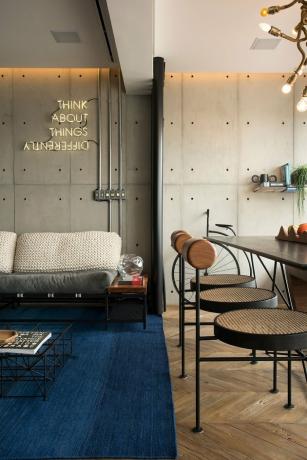 apartamento de estilo industrial com sinal de néon pendurado na parede e lustre exclusivo