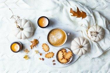 Autunno accogliente sfondo vacanza con tazza di caffè, biscotti e zucche